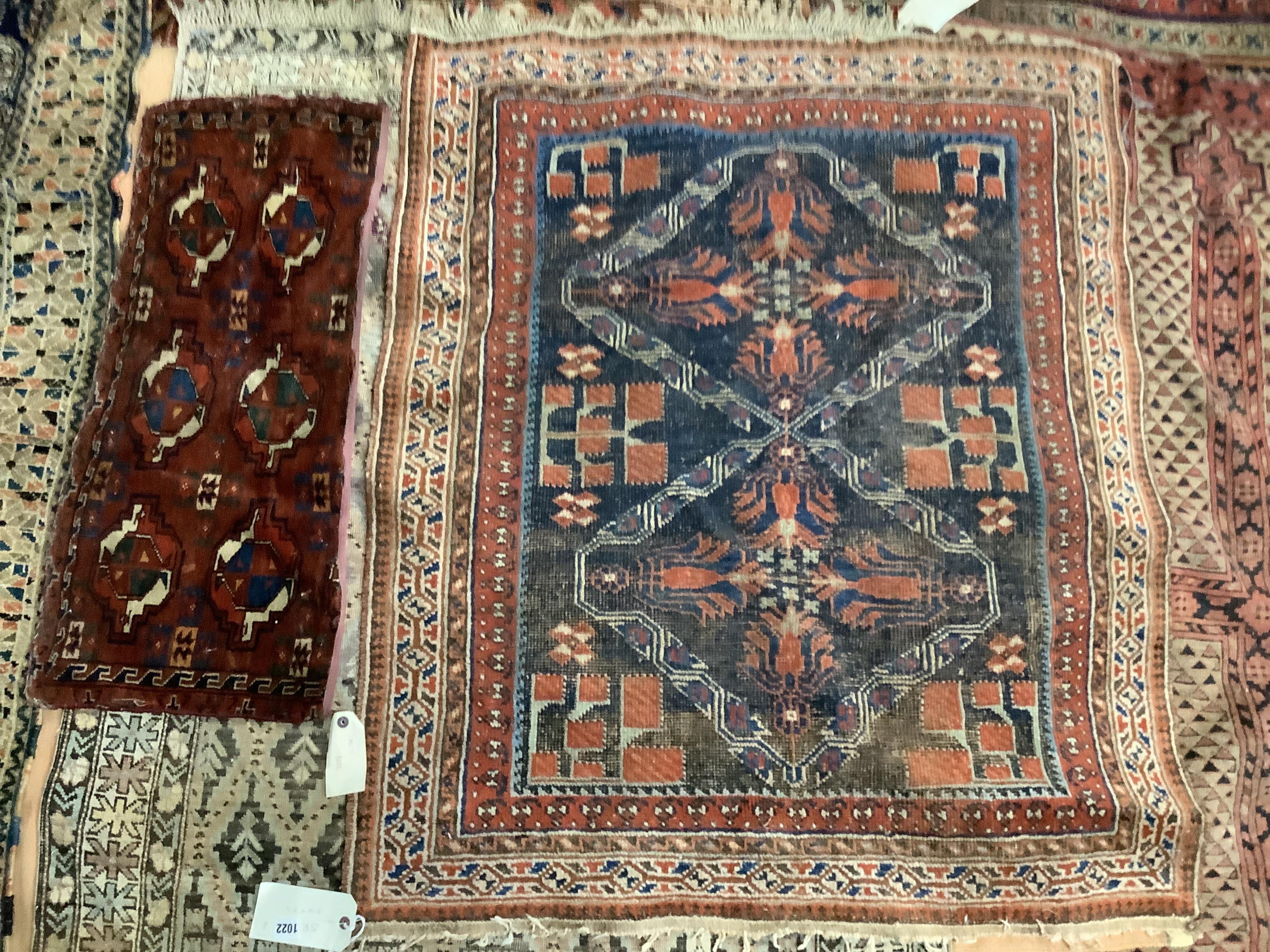 A Caucasian blue ground rug, 118 x 100cm and a Turkestan Bukhara, camel trapping, 83 x 34cm